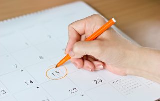 a woman who has irregular periods, marking the date in her calendar, wondering about causes of irregular bleeding