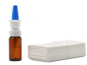 Nasal,Spray,And,A,Stack,Of,Paper,Tissues,On,A Acid Reflux or GORD