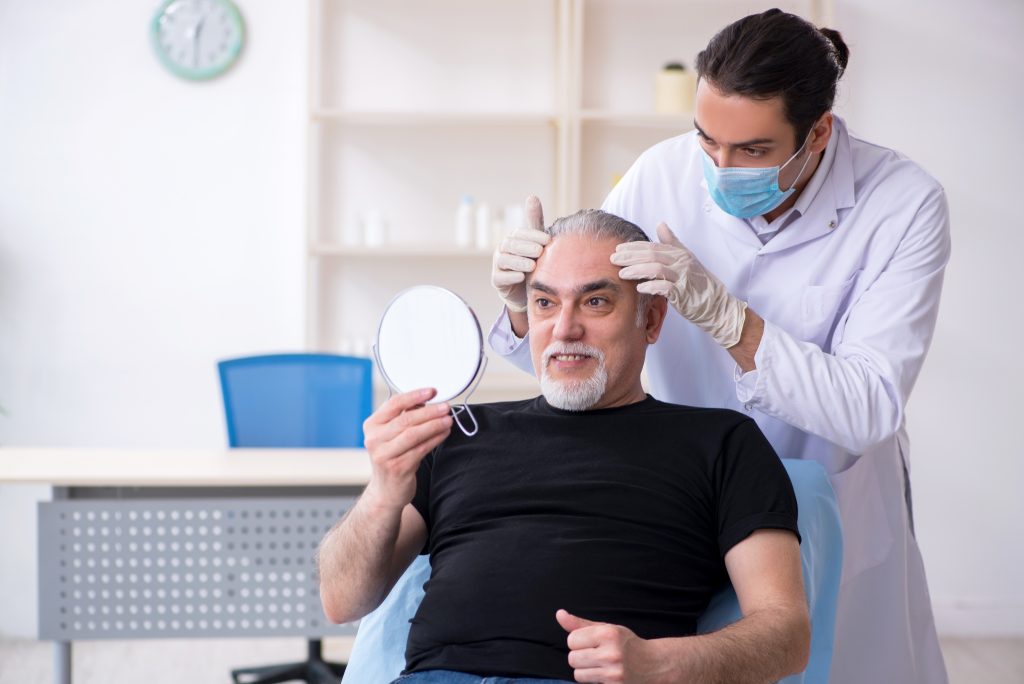 Old,Man,Visiting,Young,Doctor,For,Plastic,Surgery Plastic surgeons usually have upwards of ten years of training under their belt and are accredited with the Royal Australian College of Surgery (RACS)