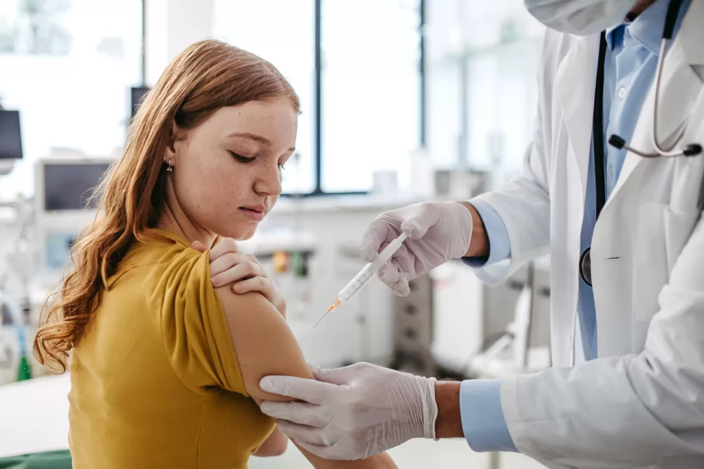 Doctor-injecting-HPV-vaccine-into-teenage-girl-arm-scaled Doctor injecting HPV vaccine into teenage girl arm
