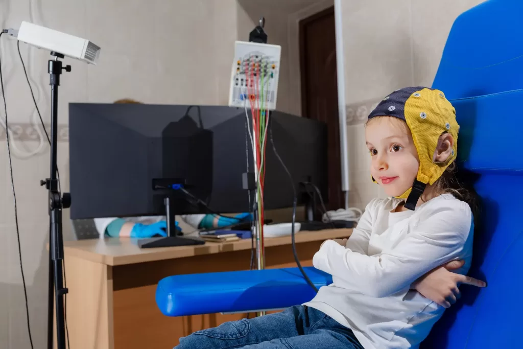 EEG electroencephalogram is conducted in a clinic on a child’s head EEG electroencephalogram is conducted in a clinic on a child's head
