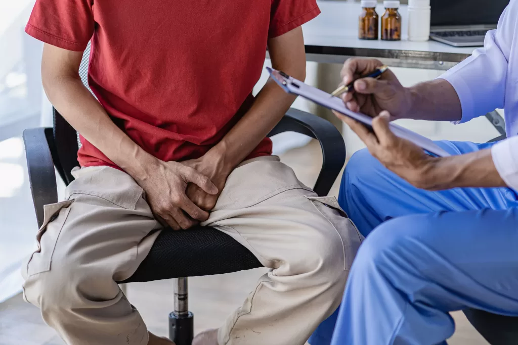 A-doctor-is-consulting-with-a-young-man-about-scrotal-angiokeratoma-scaled A doctor is consulting with a young man about scrotal angiokeratoma