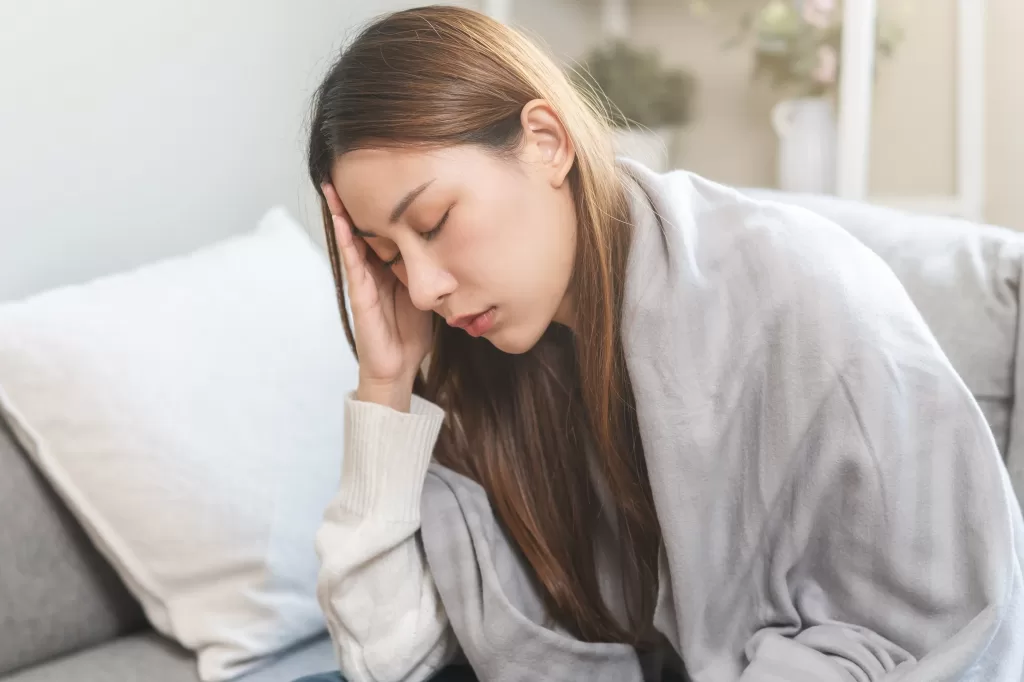 Woman-with-dengue-touches-her-forehead-having-a-headache-and-fever-scaled Woman with dengue touches her forehead having a headache and fever